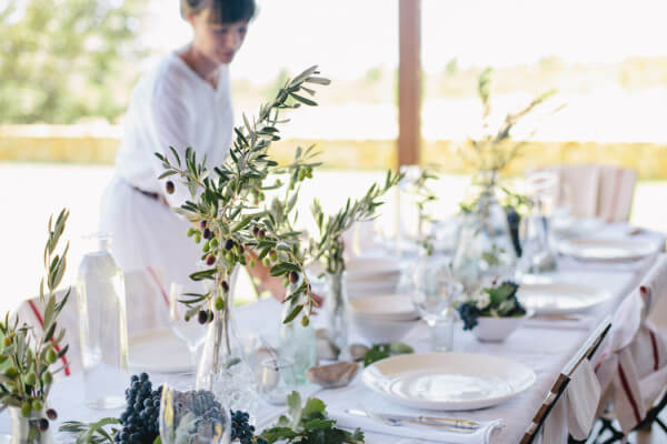 Setting_table_behind_olive_branch Setting_table_behind_olive_branch